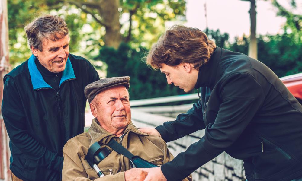 Family Helping Elderly Man