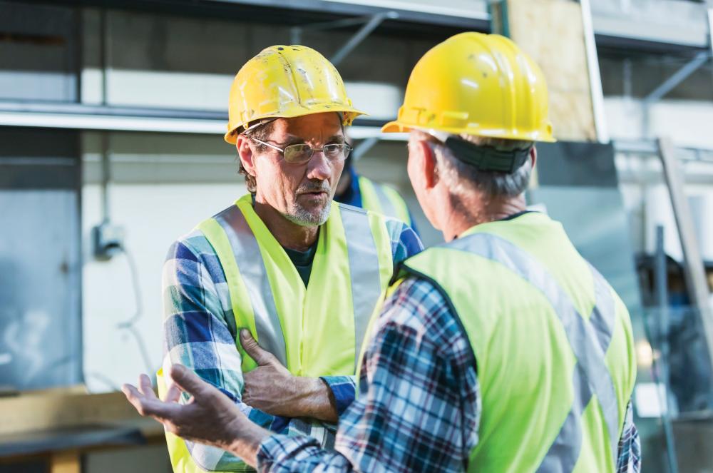 Two men at work talking.